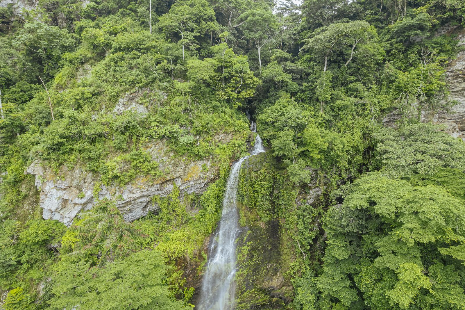 Waterfall cliff over restored land.